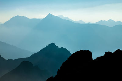 Scenic view of silhouette mountains against sky