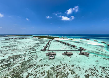 Maldives, kaafu atoll, aerial view of resort bungalows on lankanfushi island