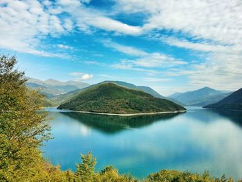 Scenic view of lake and mountains against sky