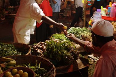 Group of people at market stall