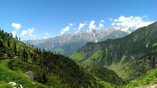 Scenic view of mountains against cloudy sky