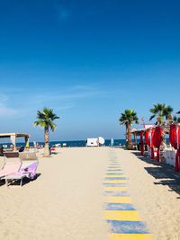 Scenic view of beach against clear blue sky