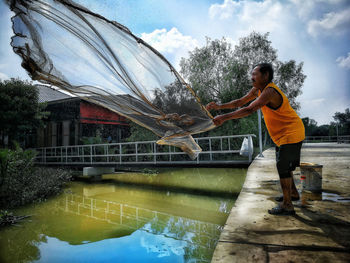 Rear view of man standing in water