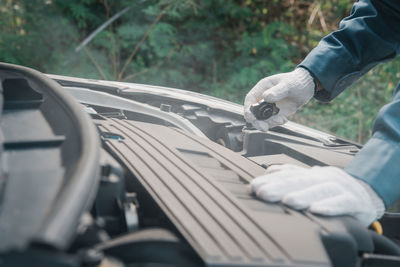 Low section of man repairing car