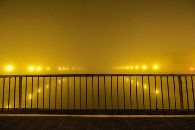 Illuminated suspension bridge against clear sky at night