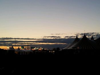Built structures against sky at sunset