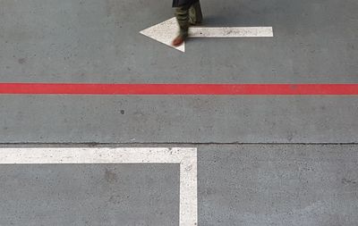 Low section of person walking on road