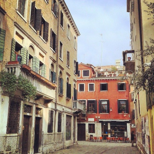 building exterior, architecture, built structure, street, city, building, residential building, residential structure, sky, transportation, city life, road, window, outdoors, day, city street, incidental people, old town, car, the way forward