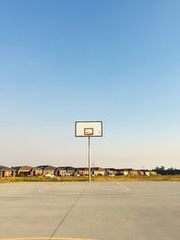 View of basketball hoop against clear blue sky