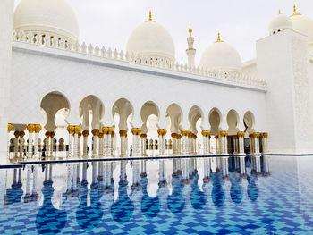 Reflection of mosque in swimming pool
