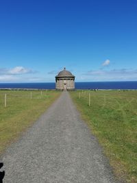Built structure on field against sky
