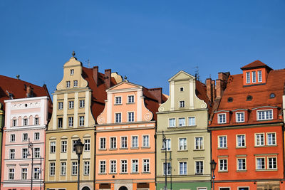 Low angle view of buildings against blue sky