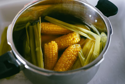High angle view of boiled corn in bowl on table