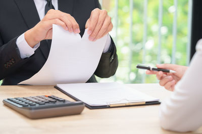 Cropped image of people on table