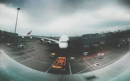 Cars on road against cloudy sky