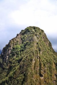 Low angle view of rocks on mountain against sky