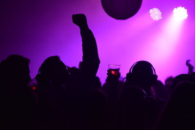 Silhouette of people at music concert