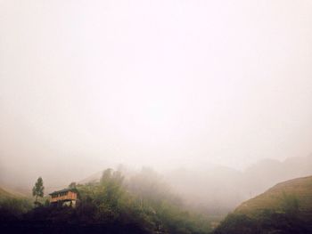 Scenic view of mountains in foggy weather