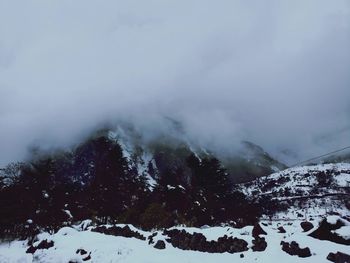 Scenic view of mountains against sky during winter