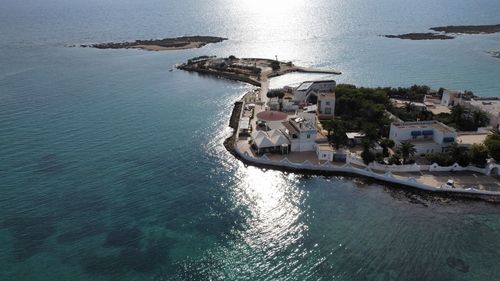 High angle view of buildings by sea