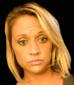 Close-up portrait of a beautiful young woman over black background