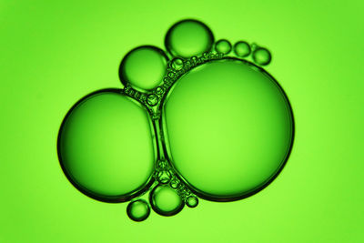 Close-up of bubbles over green background