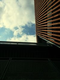 Low angle view of building against cloudy sky