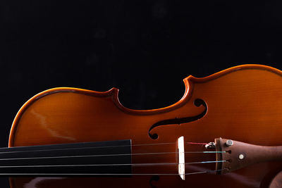Close-up of piano against black background