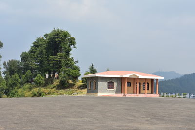 Building by road against sky