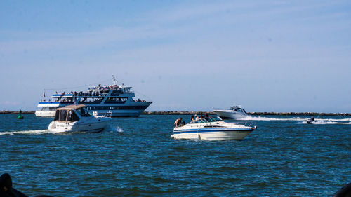 Ship sailing in sea against sky