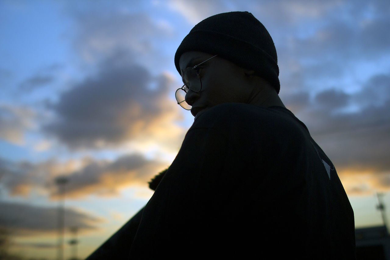 SILHOUETTE OF WOMAN AGAINST SKY DURING SUNSET