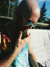 Bald man sitting outdoors