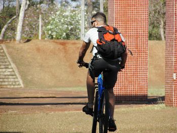 Rear view of man riding bicycle