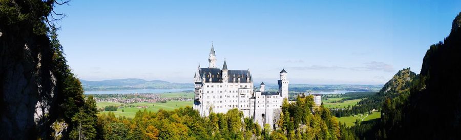 Neuschwanstein castle amidst trees against sky