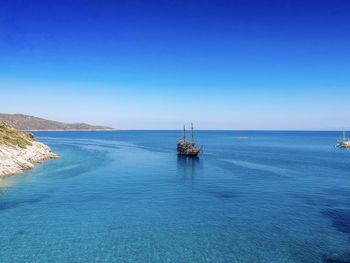 Scenic view of sea against clear blue sky