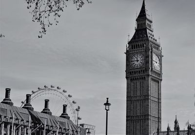 Low angle view of clock tower against sky in city