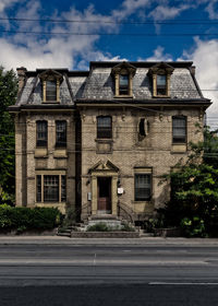 Building by road against sky