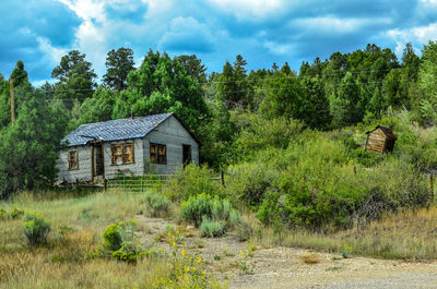 Abandoned house on field against sky