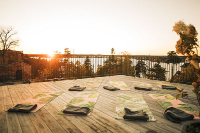 Exercise mats arranged on patio at sunset