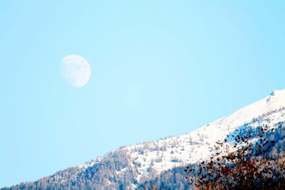 Low angle view of mountains against blue sky