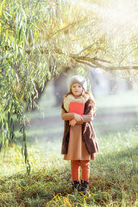 Portrait of woman standing on field