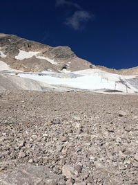 Scenic view of snowcapped mountains against blue sky