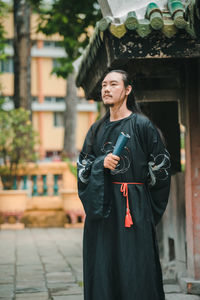Portrait of young woman standing outdoors