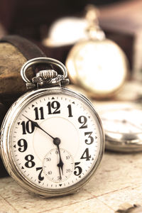 Close-up of pocket watch on table