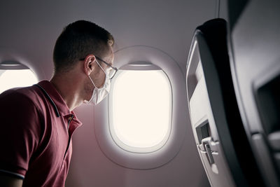 Midsection of man sitting in airplane