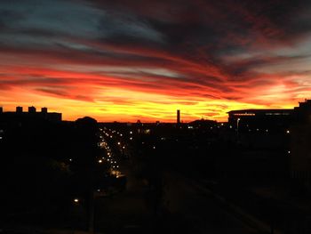 Silhouette cityscape against sky during sunset