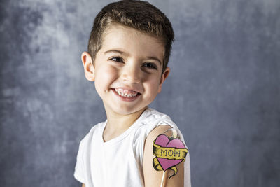 Close-up of smiling boy holding prop