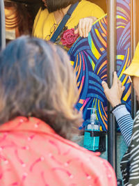 Women standing at entrance of vehicle