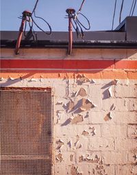 Low angle view of house roof against wall