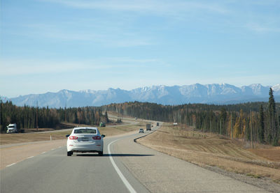 Cars on road against sky